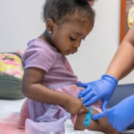 Child receiving immunization at ULPS Clinic